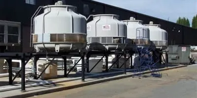 Rooftop-mounted commercial cooling tower installation with multiple cells